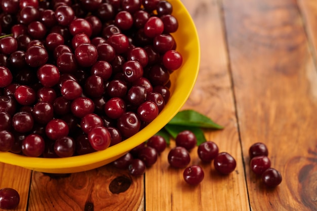 Cerezas en un plato en el primer plano de la mesa