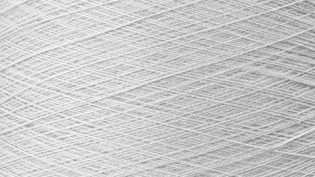 Cerrar la imagen de textura de la bobina de hilo de coser de color gris plateado de fondo macro