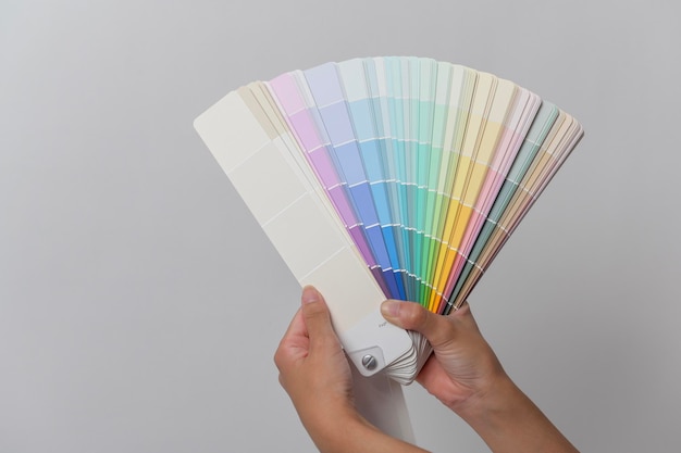 Cerrar mujer mano sosteniendo color pantone Diseño sobre fondo blanco