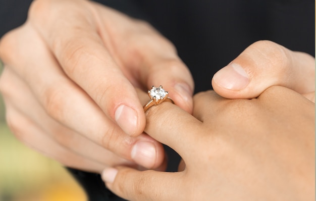 Cerrar el novio poniendo el anillo de bodas en la novia