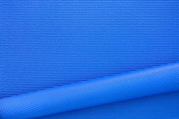 Foto cerrar rollo color azul yoga mat textura del fondo