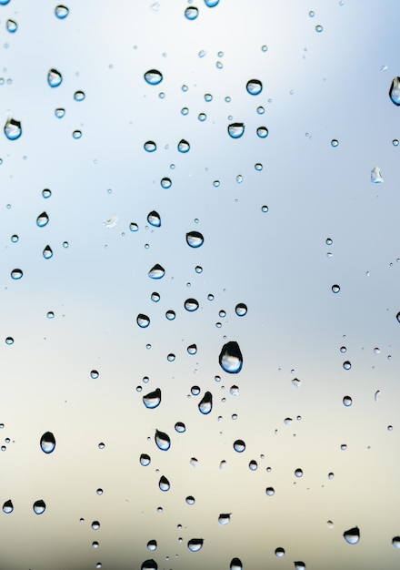 Foto cerrar la textura de las gotas de agua sobre el vidrio causada por la lluvia