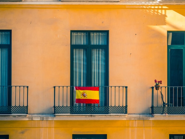 Cerrar vista de fachada con ventanas y banderas españolas