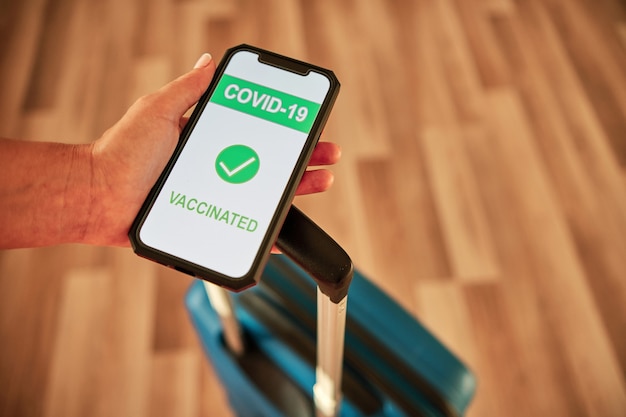 Certificado de vacinação Covid-19 no smartphone - conceito de viagens