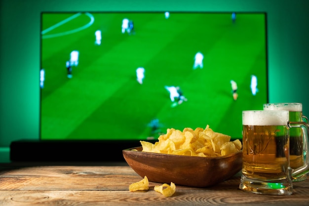 Cerveja e lanches no fundo da TV do jogo de futebol