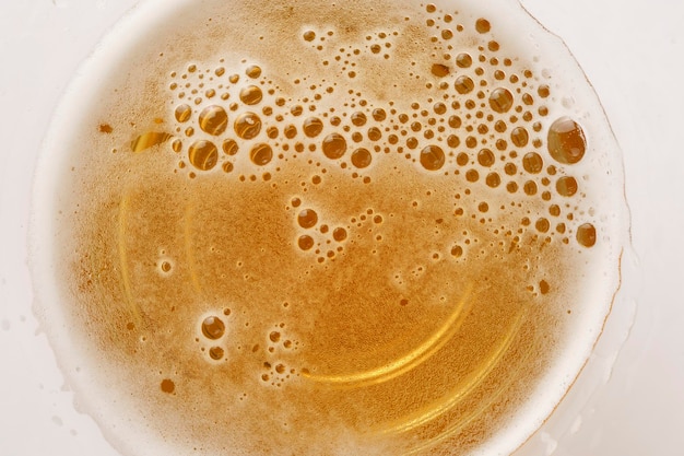 Cerveza ligera en un vaso con espuma y burbujas