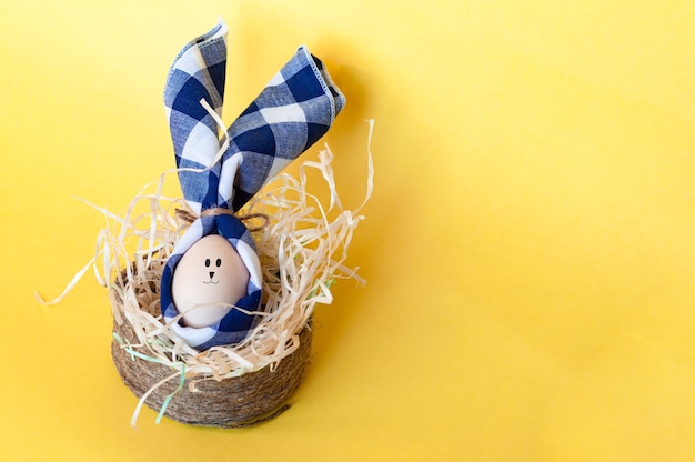 Cesta de mimbre con conejito de Pascua en amarillo