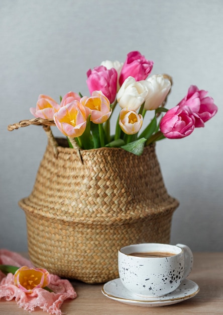 Cesta con tulipanes de colores de primavera sobre la mesa