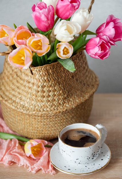 Cesta con tulipanes de colores de primavera sobre la mesa