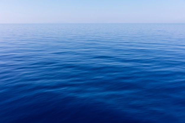 Céu azul e fundo calmo da água do mar do oceano