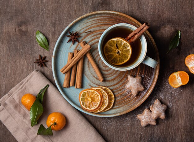 Chá com tangerina e canela com pão de gengibre em uma mesa de madeira