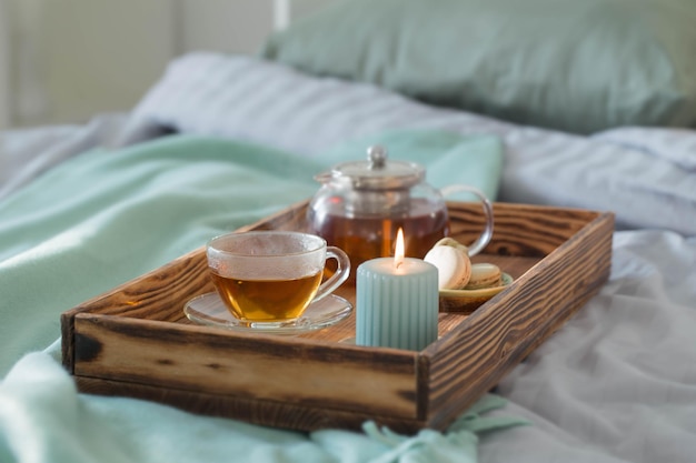 chá na bandeja de madeira na cama em casa