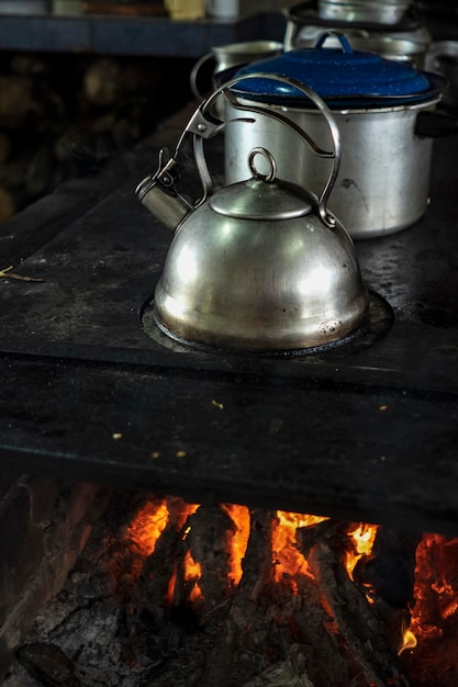 Chaleira de aço inoxidável em um fogão a lenha