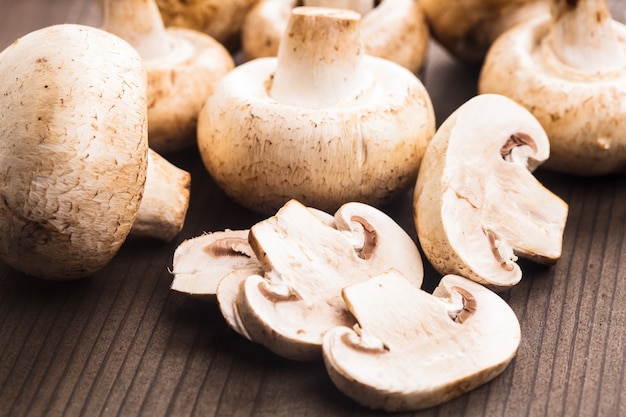 Champignons und Scheiben auf der Holztischnahaufnahme