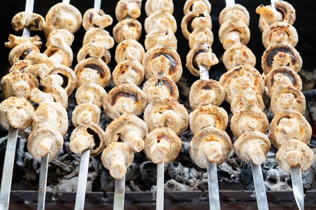 Los champiñones marinados en mayonesa se asan a la parrilla. Un refrigerio rápido en un picnic