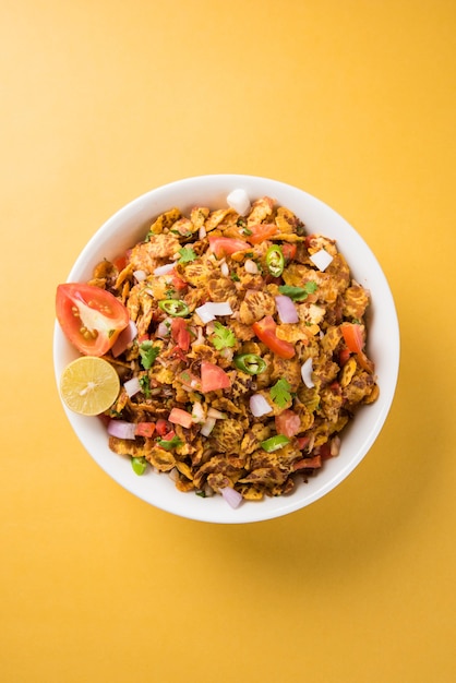 Chana chor jor garam - bate-papo picante indiano à beira da estrada ou lanches, servido em um prato ou tigela sobre um fundo colorido ou de madeira. foco seletivo