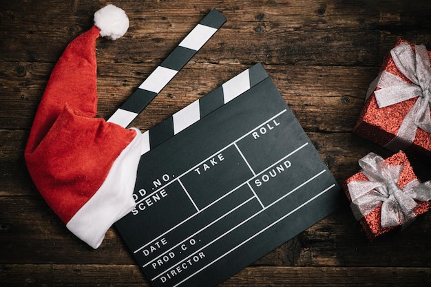 Chapéu de Natal com recorte de placa de filme na mesa de madeira