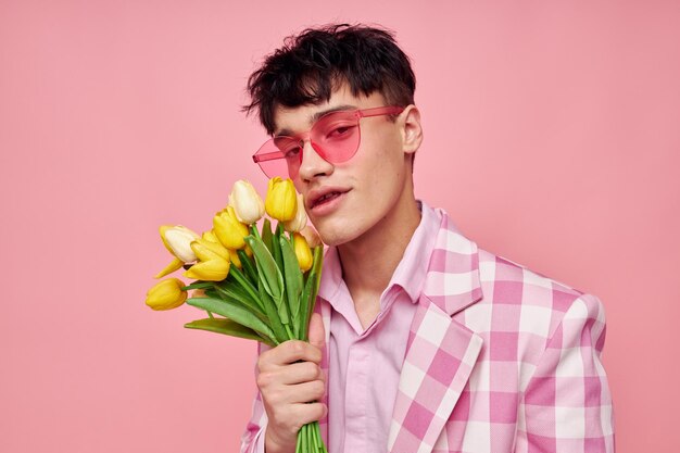 Chaqueta de gafas de sol rosa de moda de hombre bonito posando fondo rosa inalterado