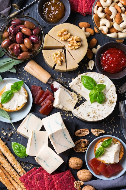 Charcuterie-Teller serviert mit fermentiertem Bio-Rohkäse aus Cashewnüssen mit Snacks, Früchten. Veganes, vegetarisches, pflanzliches Essen, Ernährung und Diät, Konzept für gesunde Ernährung.