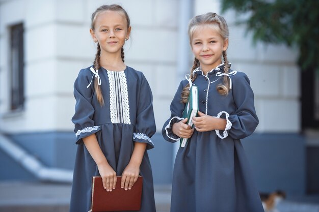 Charmante kleine Mädchen im Retro-Kleid, die an einem sonnigen Sommertag in der Stadt gehen.