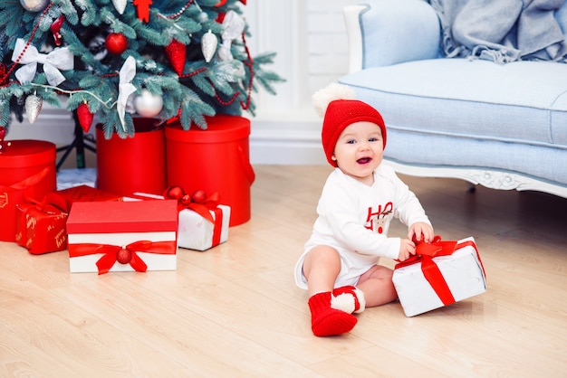 Charmanter Kleinkindjunge hält Weihnachtsgeschenkbox. Konzept der Weihnachtsferien.