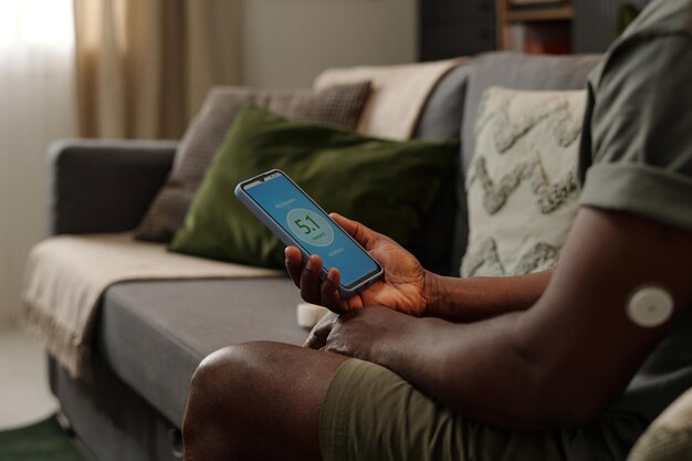 Checking Health Data on Smart Device While Relaxing at Home