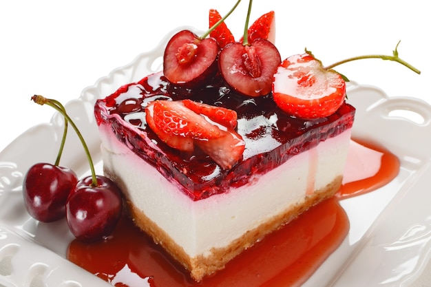 Cheesecake com frutas vermelhas, morango fresco e cheesecake de cereja na mesa.