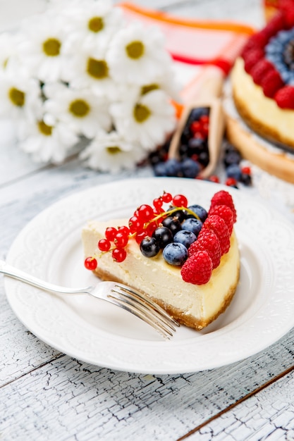 Cheesecake de framboesa e mirtilo na mesa de madeira