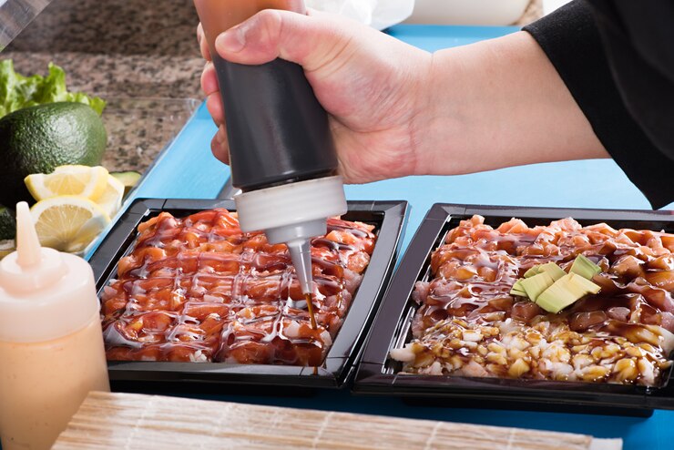 Foto chef, adicionando molho de comida japonesa