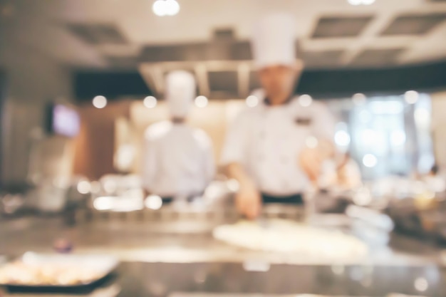 Chef cocinando en la cocina del restaurante fondo desenfocado borroso