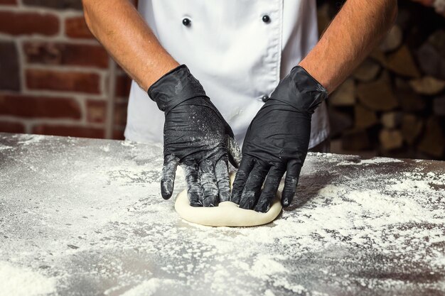 Chef fazendo massa para pizza Mãos de homem preparando pão Conceito de panificação e pastelaria