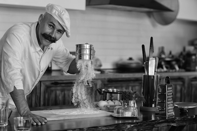 chef francês na cozinha preparando comida, cozinhando, alta cozinha, homem com bigode
