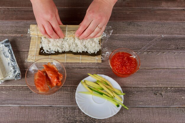 Chef japonés haciendo sushi de salmón - comida japonesa