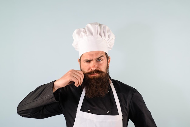 Chef profesional hombre hombre cocinero con sombrero de chef y uniforme chef barbudo con sombrero de cocinero jefe hombre en uniforme