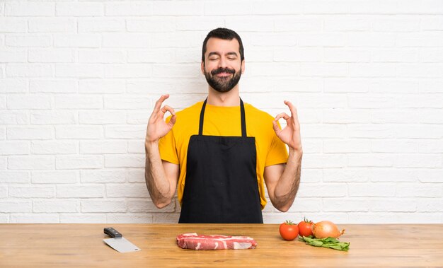 Chef, segurando em uma cozinha em pose de zen