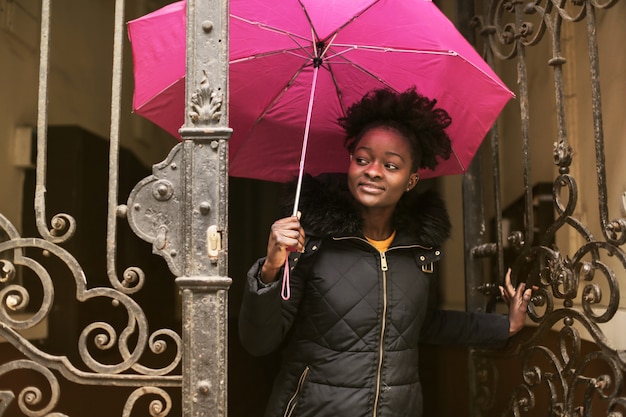 Chica afro saliendo de un edificio