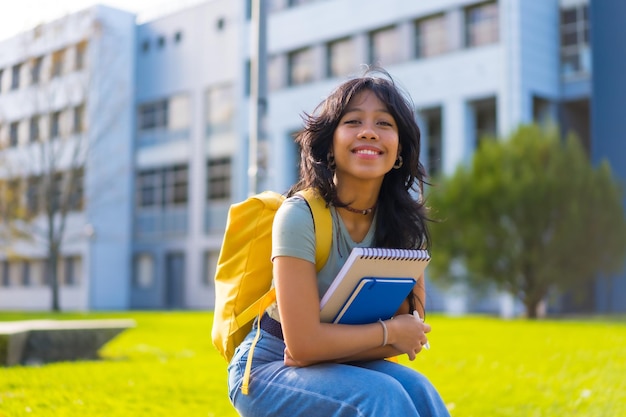 Chica asiática en estudiante del campus disfrutando de clases sonriendo en la universidad sentado