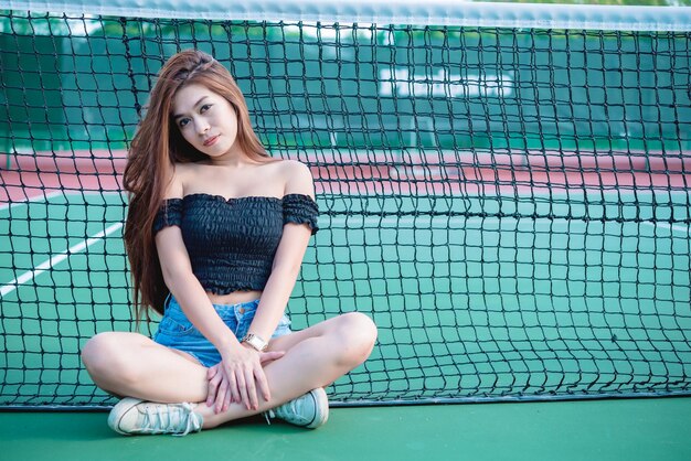 Chica asiática hipster posar para tomar una foto Retrato de moda mujer bonita en la cancha de tenis estilo de vida de una adolescente tailandesa moderna