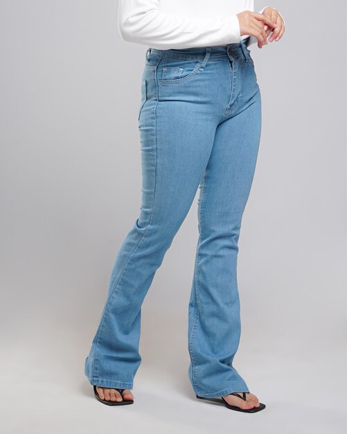 Chica asiática pañuelo en la cabeza con pantalones largos sobre fondo blanco.