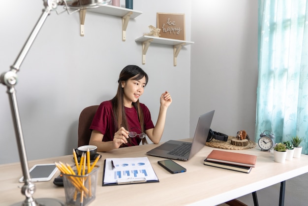 Chica asiática trabajando remotamente desde casa