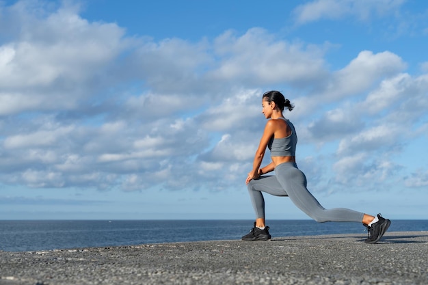 Foto chica atlética morena haciendo ejercicio haciendo ejercicios llevando un estilo de vida saludable