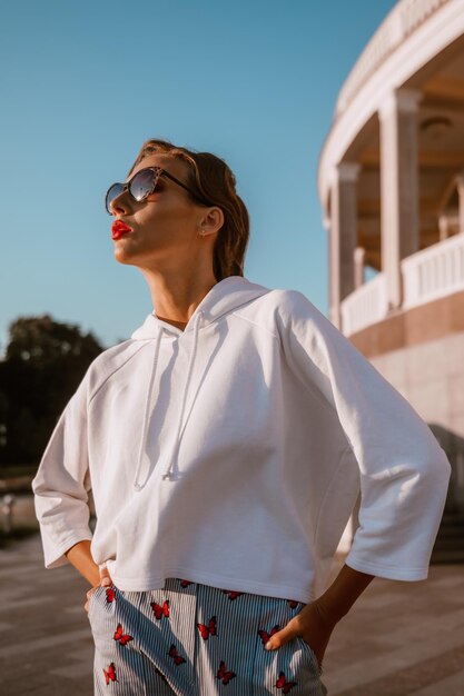 chica atractiva con traje de verano y gafas de sol descansa en el resort