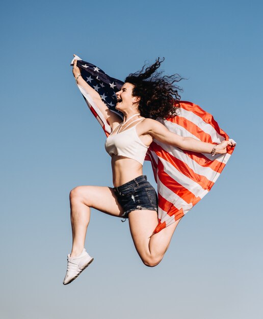 Foto chica con una bandera americana día de la independencia