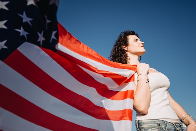 Foto chica con una bandera americana día de la independencia