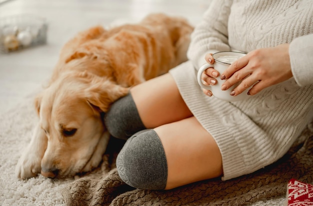 Chica con cacao y perro golden retriever