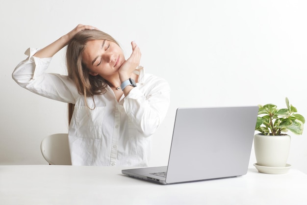 Chica calentándose frente a una computadora portátil en un fondo blanco