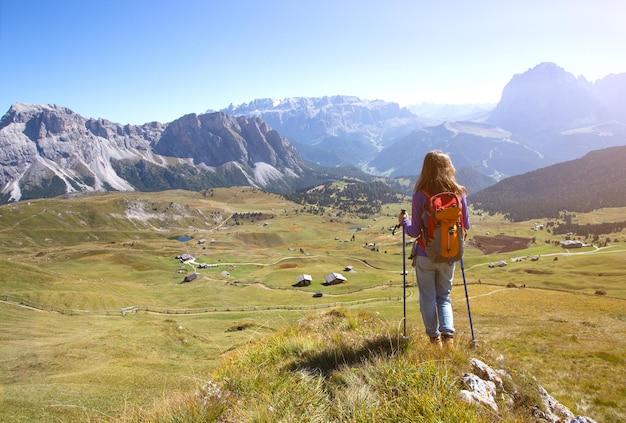 Chica caminante en las montañas Dolomitas y vistas al valle, Italia. Seceda