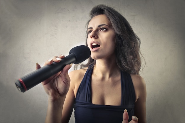 Chica cantando en un micrófono