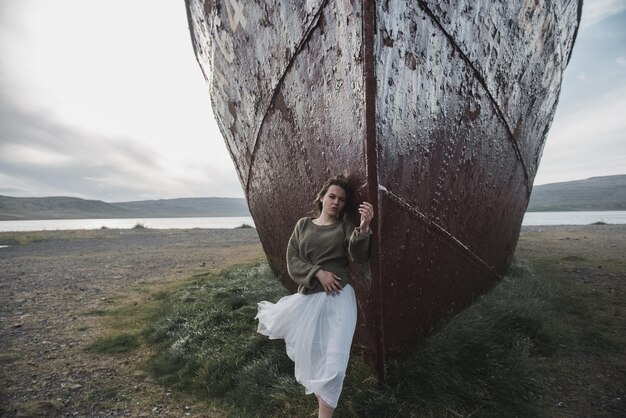 chica cerca del enorme barco en Islandia