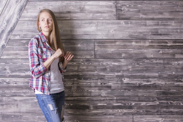 Chica contra la pared de madera